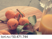 loquats on kitchen counter background. Vintage style. Стоковое фото, агентство Ingram Publishing / Фотобанк Лори