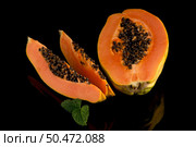 Fresh and tasty papaya on black background. Стоковое фото, агентство Ingram Publishing / Фотобанк Лори