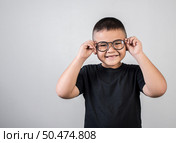 Funny boy genius wearing glasses in studio shot. Стоковое фото, агентство Ingram Publishing / Фотобанк Лори