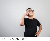 Funny Genius boy Thinking in studio shot. Стоковое фото, агентство Ingram Publishing / Фотобанк Лори