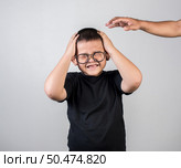 Boy feels sad after the parents scold him. Стоковое фото, агентство Ingram Publishing / Фотобанк Лори