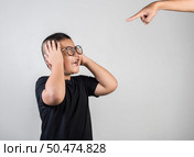 Boy feels sad after the parents scold him. Стоковое фото, агентство Ingram Publishing / Фотобанк Лори