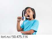 little girl brushing her teeth in studio shot. Стоковое фото, агентство Ingram Publishing / Фотобанк Лори