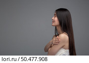 The woman is wearing a strapless shirt that stands with her arms crossed,Taken from the left hand side. Стоковое фото, агентство Ingram Publishing / Фотобанк Лори