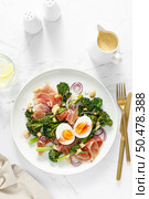 Easter egg salad with prosciutto and broccolini on white background, top view. Easter salad with boiled egg. Стоковое фото, агентство Ingram Publishing / Фотобанк Лори