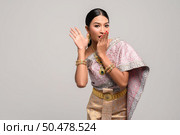 women is wearing Thai clothes and hand-made to cover her mouth. Стоковое фото, агентство Ingram Publishing / Фотобанк Лори