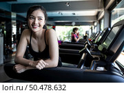 Beautiful fitness women prepare for running at the treadmill in the gym. Стоковое фото, агентство Ingram Publishing / Фотобанк Лори