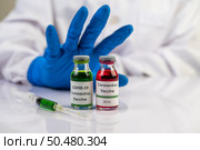 Scientists wear blue gloves and make hands unacceptable vaccine  Selective focus. Стоковое фото, агентство Ingram Publishing / Фотобанк Лори