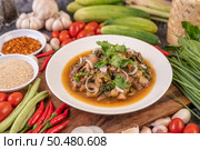 Spicy minced pork in a white plate with Tomatoes, garlic, long beans, sliced ??shallots, chili powder, roasted rice. Стоковое фото, агентство Ingram Publishing / Фотобанк Лори