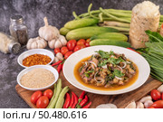 Spicy minced pork in a white plate with Tomatoes, garlic, long beans, sliced ??shallots, chili powder, roasted rice. Стоковое фото, агентство Ingram Publishing / Фотобанк Лори