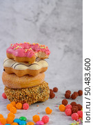 Assorted stack donuts and strawberry bitten donuts placed on top. Стоковое фото, агентство Ingram Publishing / Фотобанк Лори