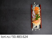 Noodles spicy in Wooden tray with ingredients on black cement background, Top view. Стоковое фото, агентство Ingram Publishing / Фотобанк Лори