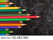 colorful crayon pencils with triangle shape on white background with copy space. Top view. Стоковое фото, агентство Ingram Publishing / Фотобанк Лори
