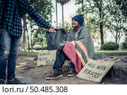 Beggars wrapped in cloth and then put on a hat and sat down beside the street and someone gave money. Стоковое фото, агентство Ingram Publishing / Фотобанк Лори