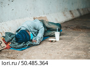 The beggars lay on their side of the street with dirty clothes. Стоковое фото, агентство Ingram Publishing / Фотобанк Лори