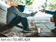 Beggars sitting under the overpass with a credit card and credit card swipe machine. Стоковое фото, агентство Ingram Publishing / Фотобанк Лори