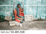 The beggars sat beside the street with a homeless message. Please help and work with food. Стоковое фото, агентство Ingram Publishing / Фотобанк Лори