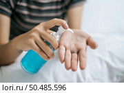 Young women clean their hands with a hand wash gel to prevent germs. Стоковое фото, агентство Ingram Publishing / Фотобанк Лори