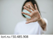 Women wear masks and forbid by raising their hands in front. Стоковое фото, агентство Ingram Publishing / Фотобанк Лори