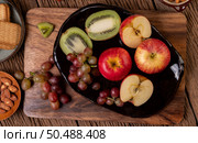 Grapes, kiwi, apples and bread on the table. Selective focus. Стоковое фото, агентство Ingram Publishing / Фотобанк Лори