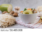 Chicken soup with corn, shiitake mushroom, enoki mushroom, and carrot. Стоковое фото, агентство Ingram Publishing / Фотобанк Лори