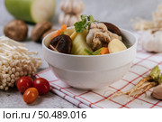 Chicken soup with corn, shiitake mushroom, enoki mushroom, and carrot. Стоковое фото, агентство Ingram Publishing / Фотобанк Лори