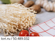 Enokitake, tomato, and red white cloth. Selective focus. Стоковое фото, агентство Ingram Publishing / Фотобанк Лори