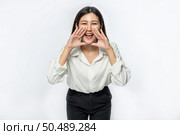 The woman wore a white shirt and black trousers and make a hand shout of joy. Стоковое фото, агентство Ingram Publishing / Фотобанк Лори