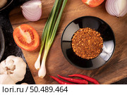 The cayenne pepper in a black plate with spring onions, chili and garlic. Стоковое фото, агентство Ingram Publishing / Фотобанк Лори