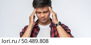 A man who is sick and touches his head with his hand. Стоковое фото, агентство Ingram Publishing / Фотобанк Лори