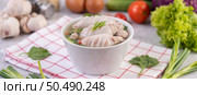 Squid soup stuffed with pork, sprinkled with coriander and chopped scallions in white cups. Стоковое фото, агентство Ingram Publishing / Фотобанк Лори