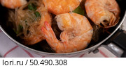 Baked shrimp with glass noodles in a deep frying pan. Стоковое фото, агентство Ingram Publishing / Фотобанк Лори