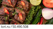 Sliced ??pork steak topped with white sesame and fresh pepper seeds along with tomatoes, lemons, chili and lettuce. Стоковое фото, агентство Ingram Publishing / Фотобанк Лори