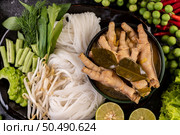 Rice noodle and Chicken feet liquid with Bitter Melon, long beans, lime, Garlic, Eggplant and Chili. Стоковое фото, агентство Ingram Publishing / Фотобанк Лори