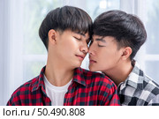 Two men who love each other hug from behind another. Стоковое фото, агентство Ingram Publishing / Фотобанк Лори