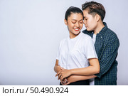 Two female lovers standing and hugging from behind. Стоковое фото, агентство Ingram Publishing / Фотобанк Лори