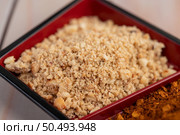 Palm sugar chopped in a cup on the wooden floor. Selective focus. Стоковое фото, агентство Ingram Publishing / Фотобанк Лори