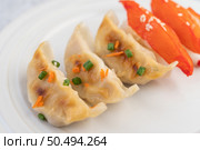 Gyoza beautifully arranged in a white plate. Стоковое фото, агентство Ingram Publishing / Фотобанк Лори