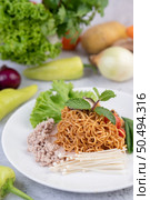 Stir-fried noodles with minced pork, edamame, tomatoes and mushrooms in a white plate. Стоковое фото, агентство Ingram Publishing / Фотобанк Лори