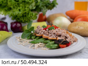 Stir-fried noodles with minced pork, edamame, tomatoes and mushrooms in a white plate. Стоковое фото, агентство Ingram Publishing / Фотобанк Лори