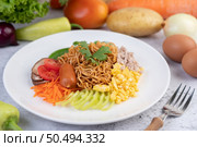 Stir-fried noodles with minced pork, edamame, tomatoes and mushrooms in a white plate. Стоковое фото, агентство Ingram Publishing / Фотобанк Лори