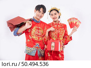 The Man and woman wear cheongsam get the red bag , gift money and some gift from their relative in traditional day. Стоковое фото, агентство Ingram Publishing / Фотобанк Лори