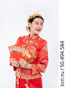 Woman wear Cheongsam suit smile to get gift money from relative in chinese new year. Стоковое фото, агентство Ingram Publishing / Фотобанк Лори
