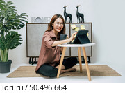 Portrait of smiling happy woman relaxing with coffee, using technology of digital pen on tablet to working from home during self-isolation and quarantine covid-19 coronavirus outbreak. Стоковое фото, агентство Ingram Publishing / Фотобанк Лори