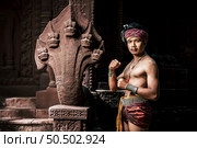 Portrait Handsome shirtless man in turban on head and beautiful silver ornament, The actor in Perform on legend love popular story, Thai Isan folktale called "Phadaeng and Nang-ai" in acient site. Стоковое фото, агентство Ingram Publishing / Фотобанк Лори