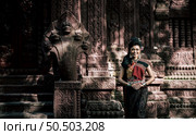 Young female Actress wearing beautiful ancient costumes, in ancient monuments, dramatic style. Perform on legend love popular story, Thai Isan folktale called "Phadaeng and Nang-ai" in acient site. Стоковое фото, агентство Ingram Publishing / Фотобанк Лори