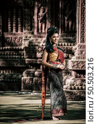 Young female Actress wearing beautiful ancient costumes, in ancient monuments, dramatic style. Perform on legend love popular story, Thai Isan folktale called "Phadaeng and Nang-ai" in acient site. Стоковое фото, агентство Ingram Publishing / Фотобанк Лори