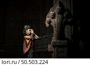 Young female Actress wearing beautiful ancient costumes, in ancient monuments, dramatic style. Perform on legend love popular story, Thai Isan folktale called "Phadaeng and Nang-ai" in acient site. Стоковое фото, агентство Ingram Publishing / Фотобанк Лори