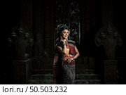 Young female Actress wearing beautiful ancient costumes, in ancient monuments, dramatic style. Perform on legend love popular story, Thai Isan folktale called "Phadaeng and Nang-ai" in acient site. Стоковое фото, агентство Ingram Publishing / Фотобанк Лори