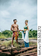 Portrait of Young man and woman wearing beautiful traditional costume which Imagination image of Thailand literature about Serpent king, Folk tales based on belief of the Isan, pose in nature outdoors. Стоковое фото, агентство Ingram Publishing / Фотобанк Лори